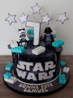 a star wars themed birthday cake with legos and stars on it's side