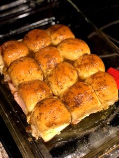 a pan filled with rolls sitting on top of an oven