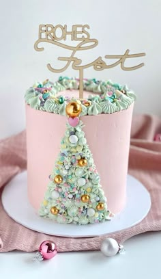 a pink cake decorated with a christmas tree