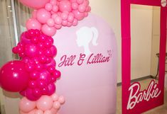 balloons are hanging on the wall in front of a barbie's sign and mirror