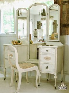 an antique vanity and chair in a room