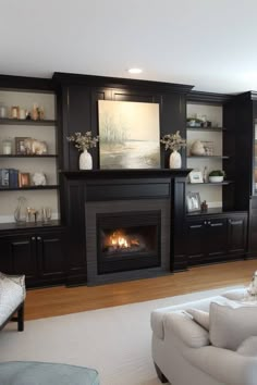 a living room filled with furniture and a fire place in the middle of it's wall