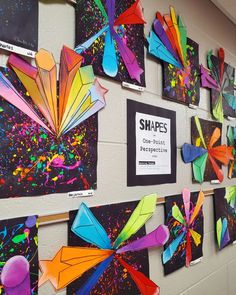 colorful art pieces are displayed on the wall in this classroom setting with information about shapes