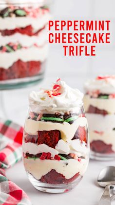 a dessert in a glass bowl with whipped cream and strawberries on top, sitting next to two other desserts