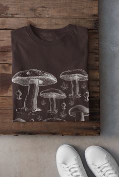 Thanks for stopping by! Cottagecore Mushroom T-shirt Printed on a super soft, cotton tee Dispatched in 5 working days or sooner Unisex Free UK delivery Material: 100% ringspun cotton. Chest (to fit): S  34/36   M  38   L  40/42   XL  44/46   XXL  48/50 ECO-FRIENDLY Each garment is made to order, reducing extra material and energy that would be otherwise wasted We use DTG printing process which is easier on the environment than screen-printing Our ink is bright and also eco-friendly. Do not tumbl Cotton T-shirt With Mushroom Print, Crew Neck, Cotton Crew Neck T-shirt With Mushroom Print, Cotton Crew Neck Tops With Mushroom Print, Crew Neck Cotton Shirt With Mushroom Print, Cotton Shirt With Mushroom Print, Cotton Crew Neck Shirt With Mushroom Print, Cotton Graphic Tee With Mushroom Design, Mushroom Tshirt, Clothing Cottagecore