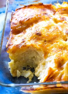 a casserole in a glass dish on a blue tablecloth with a fork