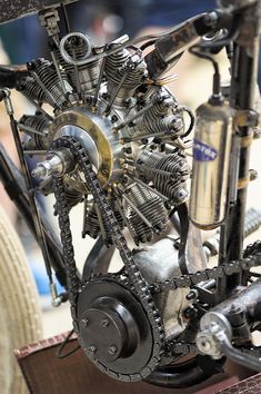 an old motorcycle engine sitting on top of a table