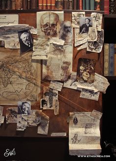 an old book shelf covered in lots of books and papers with pictures on the wall