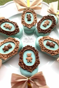 there are chocolates decorated with teddy bears in the shape of frames on a plate