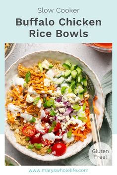 a bowl filled with rice and vegetables on top of a white tablecloth next to a fork