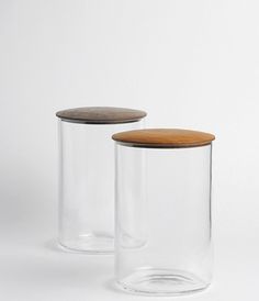 two clear glass jars with wooden lids