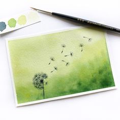 a watercolor painting of a dandelion blowing in the wind with green background