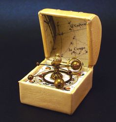 a small wooden box with some beads in it