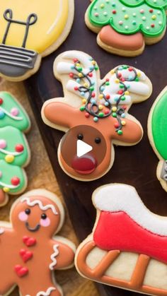 decorated christmas cookies are displayed on a table