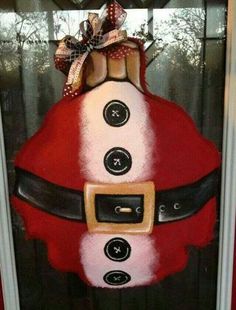 a santa clause door hanger with buttons on it's face and belt around the waist