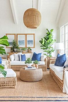 a living room with wicker furniture and plants