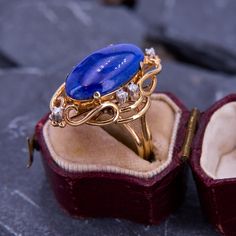 This groovy ring features a deep lapis oval cabochon accented with six round brilliant cut diamonds. Small flecks of pyrite glitter in the lapis. It is crafted in 14k yellow gold and is currently a size 7. Luxury Oval Lapis Lazuli Rings, Luxury Lapis Lazuli Oval Rings, Oval Lapis Lazuli Rings For Formal Occasions, Formal Lapis Lazuli Oval Rings, Vintage Oval Lapis Lazuli Jewelry, Oval Lapis Lazuli Ring For Anniversary, Vintage Lapis Lazuli Oval Jewelry, Groovy Ring, Vintage Onyx Ring