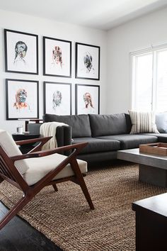 a living room filled with furniture and pictures on the wall