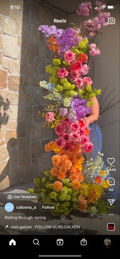 a woman standing next to a tall plant with flowers on it's side and the caption below