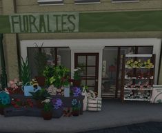 the front of a flower shop with potted plants