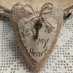 a burlap heart with a key hanging from it