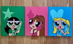 three cartoon characters painted on canvases sitting on a wooden floor