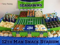 a football stadium themed dessert table with snacks