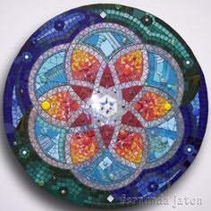 a colorful glass plate sitting on top of a table