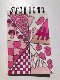 a notebook with pink and white designs on it