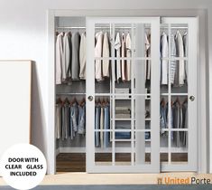 an open closet with glass doors and clothes hanging on hangers in front of it