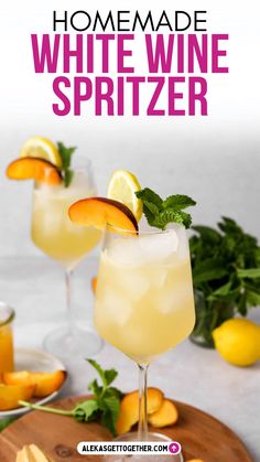 the homemade white wine spritzer is garnished with orange slices and mint