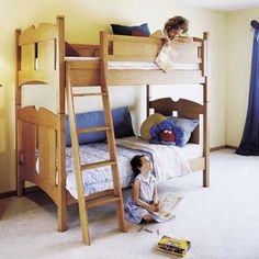 two children are sitting on the floor in front of bunk beds