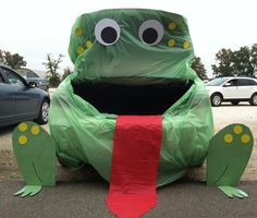 an image of a frog made out of paper on the ground with eyes and mouth