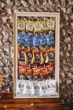 crisp wall at Cissbury Barns wedding in sussex Crisp Wedding Wall, Crisp Board Wedding, Wedding Snack Station Ideas, Wedding Crisps Wall, Wedding Crisp Wall Ideas, Crisps At Wedding, Food Walls Wedding, Crisp Table Wedding, Pallet Crisp Wall Wedding