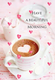 there is a cup of coffee with hearts on it and the words have a beautiful morning