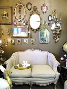 a living room filled with furniture and mirrors