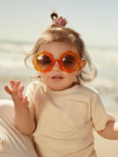 Retro sunflower petal sunglasses from Kit & Wilder. Perfect for your hippie flower child these retro sunglasses have UV protection for all the summertime playing. Add these to all your baby's summer outfits and they'll be complete. Perfect gift for the summertime baby or accessory for traveling to warmer weather with a toddler. Grab a pair for your next beach trip or day out in the sun with your kids. Shop our collection of sunglasses and baby items for your perfect boho hippie look.