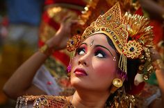 a woman in an elaborate headdress and makeup