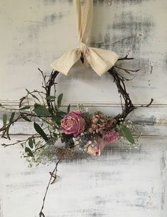 a floral wreath hanging on the side of a door