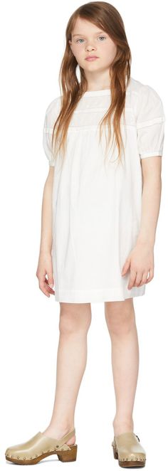 Short sleeve plain-woven cotton dress in white. Embroidery and perforated detailing at chest, sleeves, and back. · Square neck collar · Button fastening at puff sleeves · Button fastening at back · Cotton lining · Machine wash Model measures 52" / 132 cm tall and wears size 8. Supplier color: Blanc lait Bonpoint Size: child's height 4: 41.25 / 105 cm 6: 45.75 / 116 cm 8: 50.5 / 128 cm 10: 55 / 140 cm 12: 59.75 / 152 cm | Bonpoint Kids White Agathe Dress Leather Clogs, White Embroidery, Woven Cotton, Neck Collar, Kids' Dresses, Cotton Dress, Cotton Weaving, Puff Sleeves, Cotton Dresses