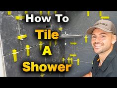 a man standing in front of a blackboard with yellow sticky notes on it and the words how to tile a shower