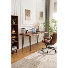 an office with a desk, chair and bookcase