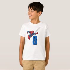 a young boy wearing a spiderman t - shirt with the number eight on it