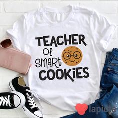 ✔️ TITTLE : Teacher Of Smart Cookies Teacher T-Shirt, Pre-K Shirt, Kindness Matters Shirt, Kindergarten Shirt, Teacher Shirt, Gift For Teacher ✔️ IMPORTANT: Both Men and Women can we our shirts because this is unisex style t-shirts; Wash item inside out in cold water, do not bleach, do not dry clean, do not iron directly on the design. ✔️ MATERIAL DETAILS: 5.3-ounce, 100% cotton (99/1 cotton/poly (Ash) & 90/10 cotton/poly (Sport Grey); Heavyweight classic unisex tee; Taped neck and shoulders; Te Cute Cotton T-shirt With Name Print, White Relaxed Fit T-shirt For School, Trendy School T-shirt With Slogan, Funny Text Relaxed Fit T-shirt For School, Casual Tops With Funny Print, Casual Cotton T-shirt For School, Funny Text Print T-shirt For School, White T-shirt With Funny Text For School, Cute Slogan Tops For School