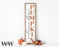 a wooden sign that says pumpkin and some fruit