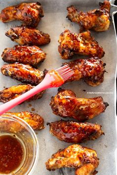 chicken wings with ketchup and sauce on a baking sheet, ready to be eaten