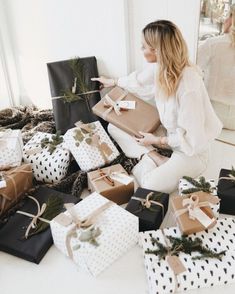 a woman sitting on the floor surrounded by presents