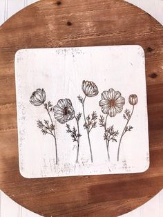 a wooden table with flowers painted on it