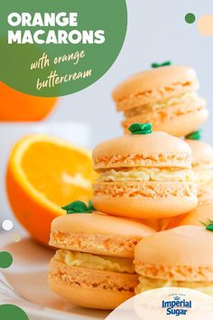 orange macaroons with orange buttercream are stacked on top of each other