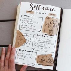 a hand holding an open book with writing on it, and the words self care